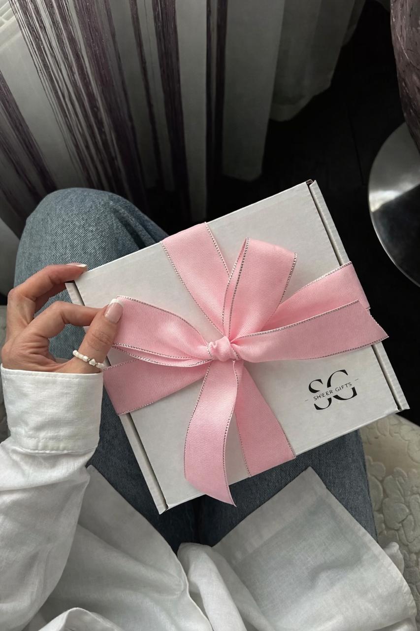 A Sheer Gifts box wrapped with a pink ribbon