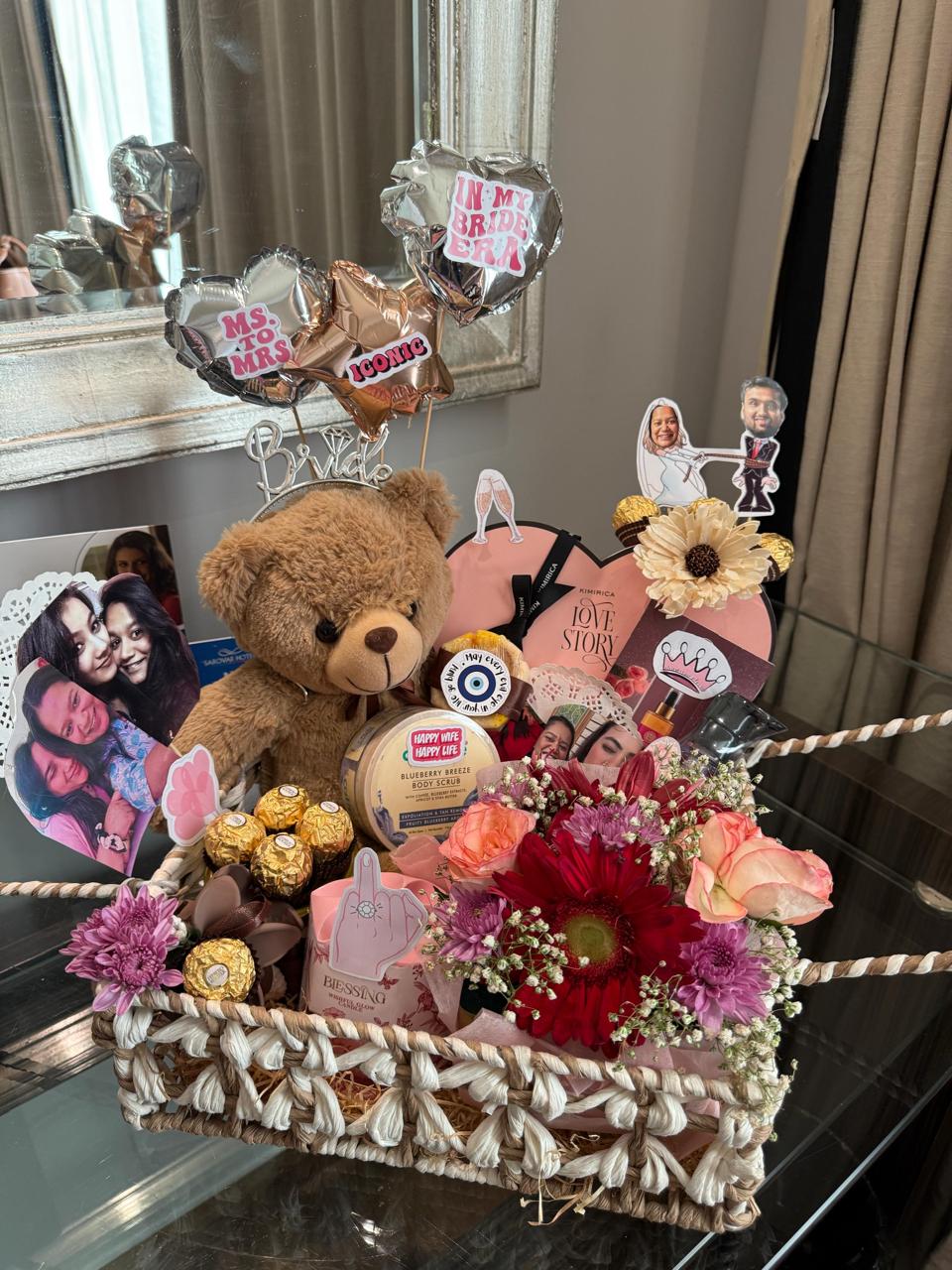 A personalised bridal hamper with flowers, photographs, chocolates and a teddy