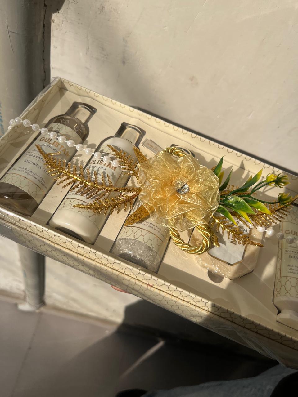 A cream and gold wellness hamper with bath and body products